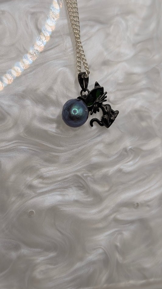 Black cat pendant with large green peacock rice