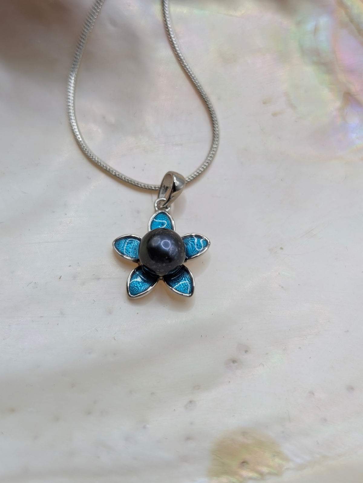 Teal flower with midnight blue pearl