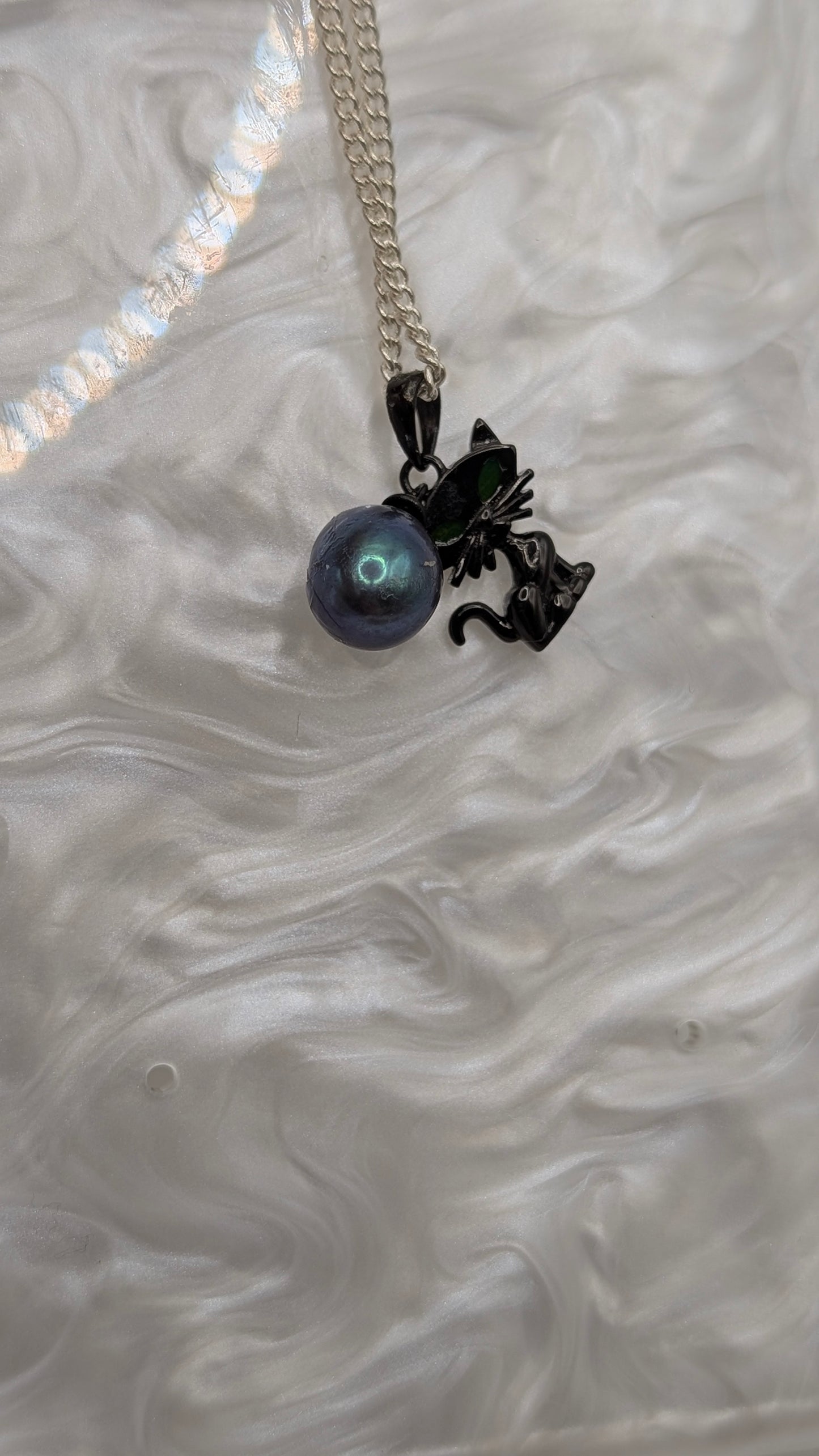 Black cat pendant with large green peacock rice