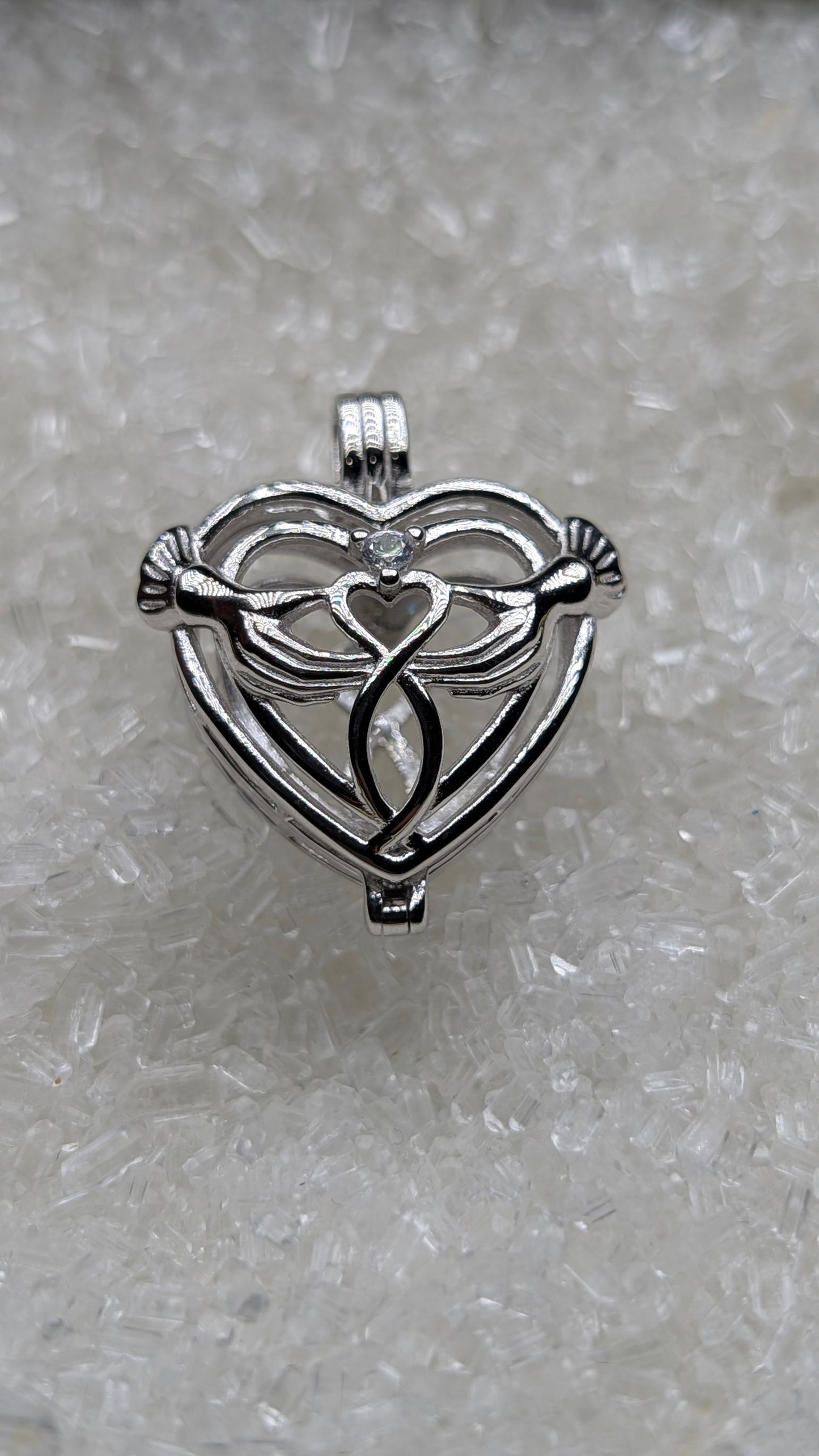 Hand holding heart large cage