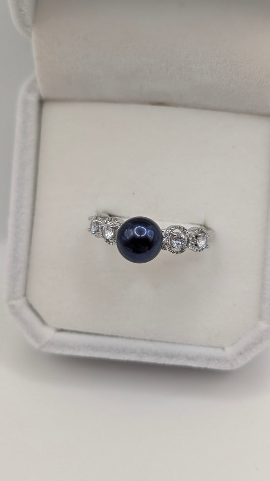 Black button pearl ring with zirconia accent stones